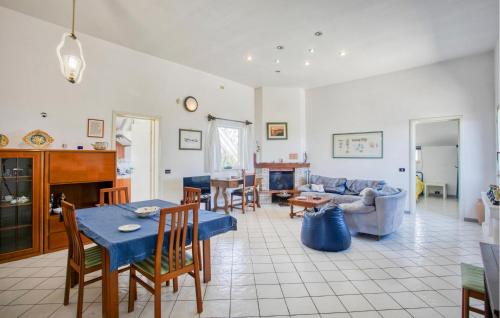 a living room with a couch and a table and chairs at 3 Bedroom Cozy Home In Rosolini in Rosolini