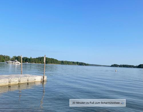 a dock in the middle of a lake at Moderne Doppelhaushälfte mit 3 SZ in der Nähe vom Scharmützelsee-seperat&naturnah in Wendisch Rietz