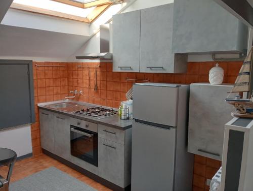 a kitchen with a white refrigerator and a sink at Case Vacanze Colombo in Civitanova Marche