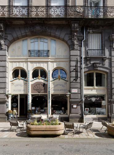 a large building with a fountain in front of it at Le Boudoir Monsieur Aurélien - Suite Hôtelière in Le Mont-Dore