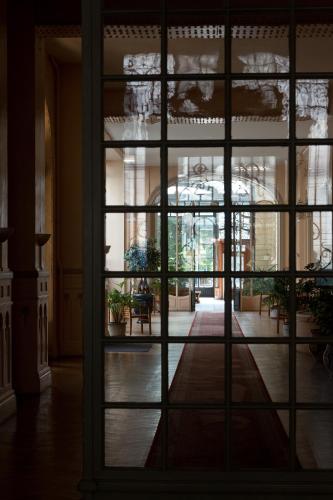 a view through a window of a building at Le Boudoir Monsieur Aurélien - Suite Hôtelière in Le Mont-Dore