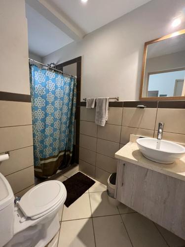 a bathroom with a toilet and a sink and a shower at Beach Dreams Coco - 60 meters from Beach in Coco