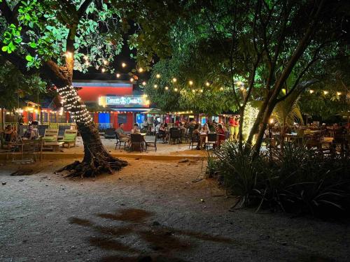 a group of tables and chairs and a tree at Cabaa En El Sol Cabin In The Sun in Ocotal