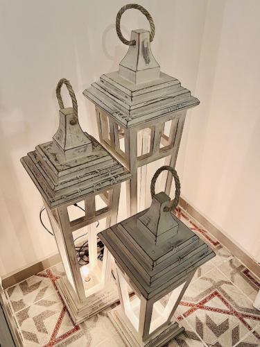 two metal lanterns sitting on top of a floor at Ma Maison Gleem, Alexandria in Alexandria