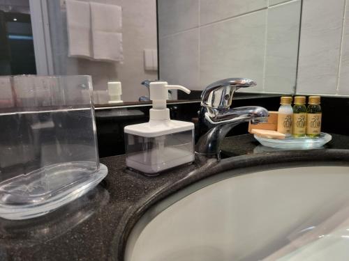 a bathroom sink with a faucet and a soap dispenser at villino indipendente eden levanto in Levanto