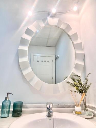 a bathroom with a mirror above a sink at Apartamento Atlántico in Rota