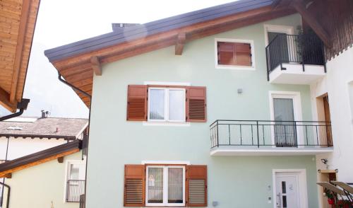 a white building with brown windows and balconies at Soggiorno Bellin in Castel Ivano