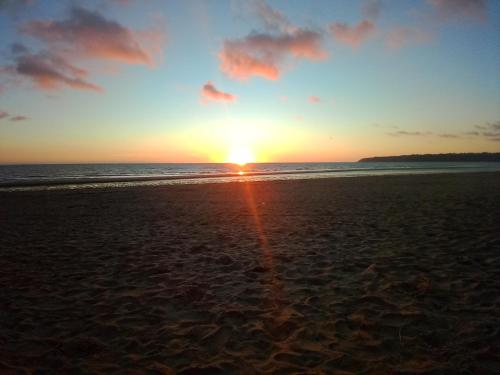a sunset on the beach with the sun setting at Gite La grange bien être en baie du Mont St Michel in Bacilly