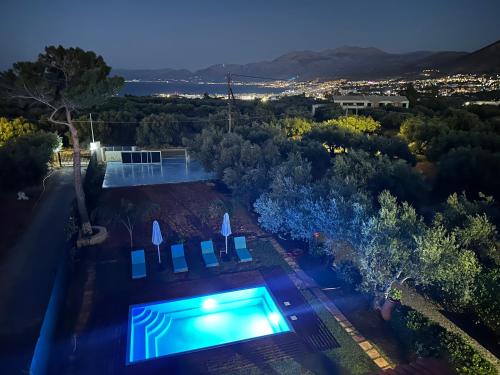 an overhead view of a swimming pool at night at Zorbas Suites in Hersonissos