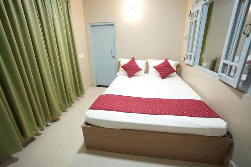 a bed in a room with green curtains at TheMapleVillageFarmstay in Gangtok