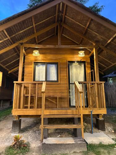 a log cabin with a porch and two windows at Barton Hills in San Vicente