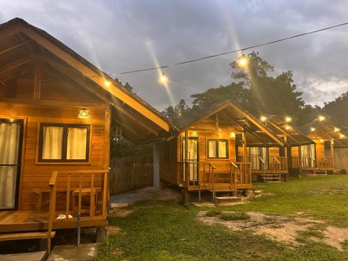 a row of wooden huts in a yard at night at Barton Hills in San Vicente