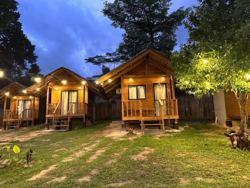 a wooden house with lights in front of it at Barton Hills in San Vicente