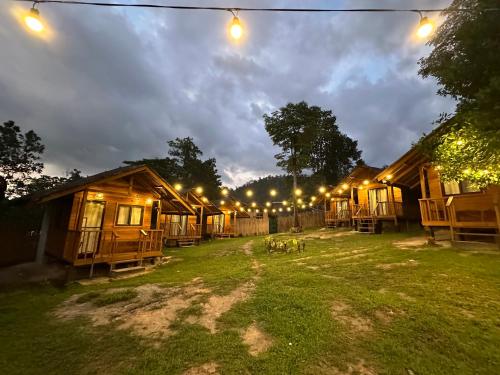 a row of lodges at night with lights at Barton Hills in San Vicente