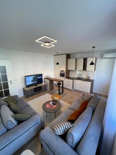 a large living room with a couch and a table at Modern Apartment in the Center of the City in Pristina
