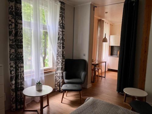 a living room with a chair and a window at Ringi studio in Pärnu