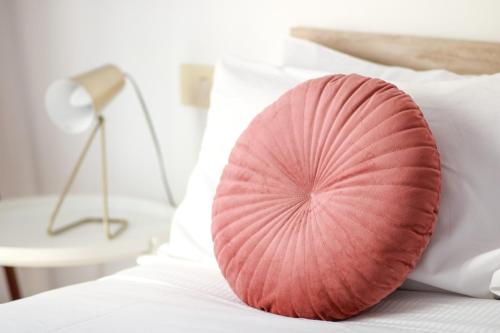 a pink pillow sitting on top of a bed at Flaminio Luxury Home - City Center in Rome