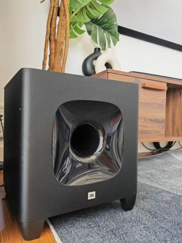 a television sitting on the floor next to a plant at Harmonee Homes at The Hub SS2, PJ in Petaling Jaya