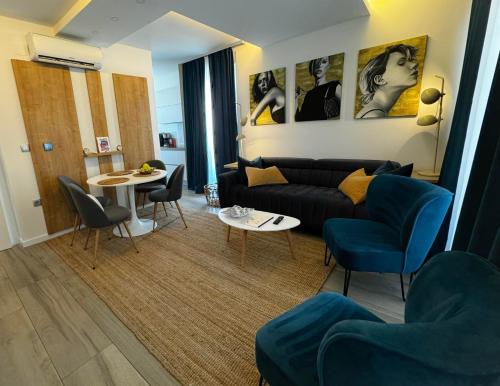a living room with a couch and a table at LuxArt City Spa Gallery Residence Krk in Krk