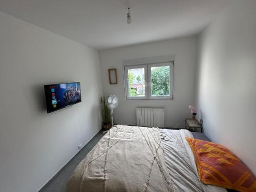 une chambre avec un lit et une fenêtre dans l'établissement Appartement - Paris, Disney, Parc des expos, Aéroport CDG, RER B, à Sevran