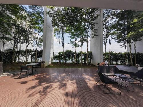 a pavilion with chairs and tables and trees at Harmonee Homes at The Hub SS2, PJ in Petaling Jaya