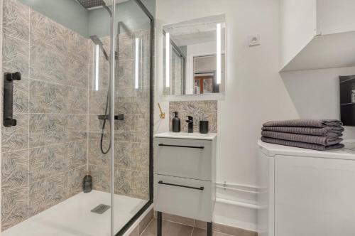 une salle de bain blanche avec une douche et un lavabo dans l'établissement Le Caraman Bohème - Confort à deux pas du métro, à Toulouse