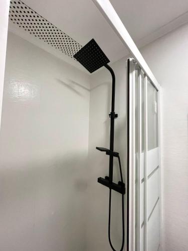 a shower in a white room with a ceiling at La Atalaya in Laredo