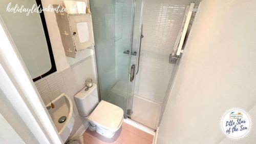 a small bathroom with a toilet and a shower at Little Star Of The Sea - Broadstairs in Kent