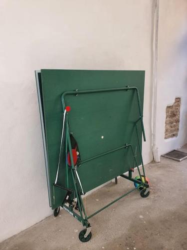 a green golf cart in a corner of a room at Ferienwohnung Maria! Respektvoller Umgang in Bad Dürkheim