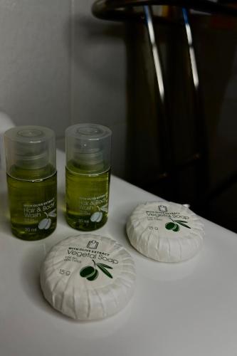 two jars of green liquid sitting on a table at A CASA DI GIANCARLA in Bologna