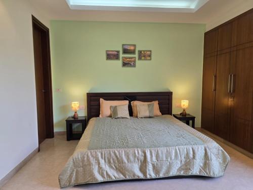 a bedroom with a large bed with two night stands at Two Green Park in New Delhi