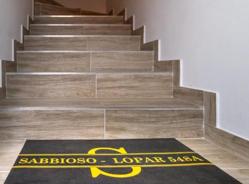 a yoga mat on the floor in front of a set of stairs at Apartmani Sabbioso in Lopar