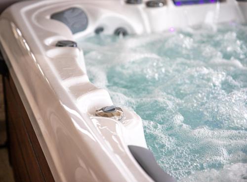 a bath tub filled with blue water with at Apartmani Sabbioso in Lopar