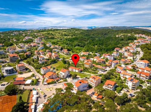 an aerial view of a city with a red marker at Apartmani Sabbioso in Lopar