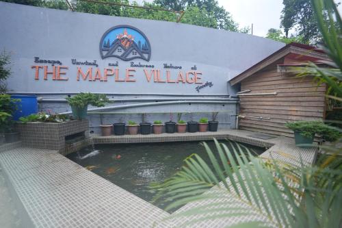 a koi pond in front of a large building at TheMapleVillageFarmstay in Gangtok
