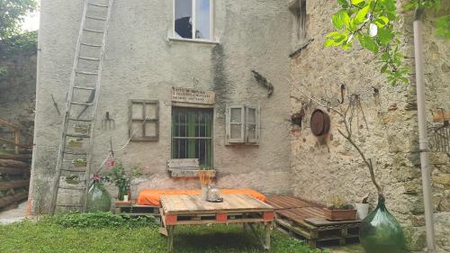 an old building with a table in front of it at A 1 passo dal bosco in Murialdo