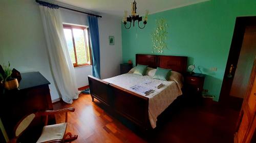 a bedroom with a bed in a room with green walls at A 1 passo dal bosco in Murialdo