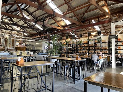 a restaurant with tables and chairs in a room at Rosa's Place Close to South Beach in South Fremantle