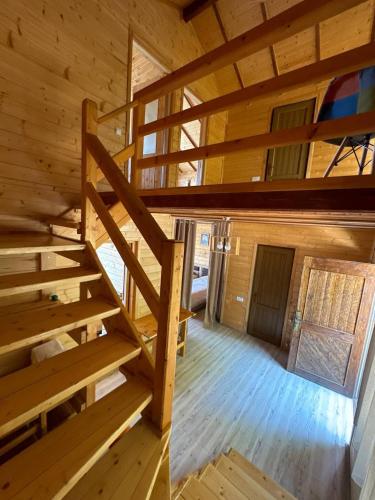 a staircase in a log cabin with wooden floors at Harsnadzor Eco Resort in Halidzor