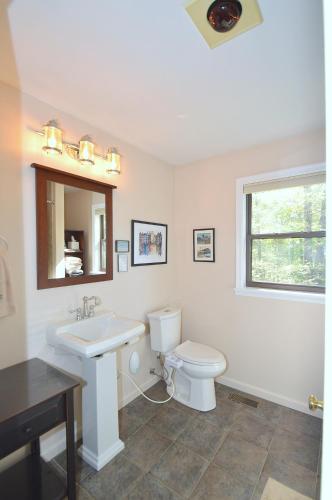 a white bathroom with a sink and a toilet at Ahh ... Riverwood in Morton Grove