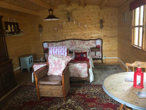 un salon avec un canapé, des chaises et une table dans l'établissement The Love Shack, à Commana