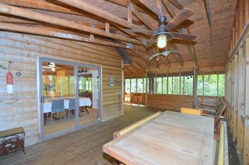 a dining room in a log cabin with a ceiling fan at Ahh ... Riverwood in Morton Grove