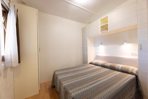 a bedroom with a bed in a room at Camping Village Le Calanchiole in Capoliveri