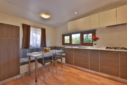 a kitchen with a table and a counter top at Camping Village Le Calanchiole in Capoliveri