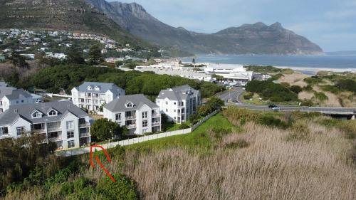 una ciudad con casas en una colina con una flecha roja en Castle View, Hout Bay, en Ciudad del Cabo