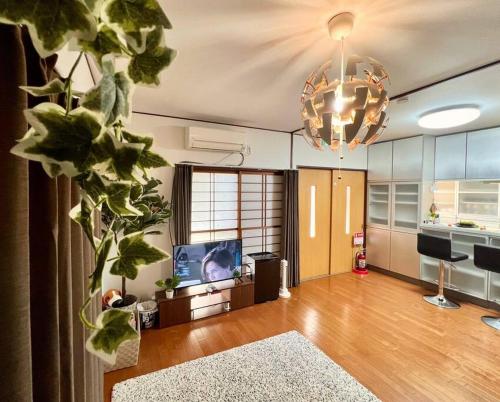 a large living room with a chandelier and a living room at FUKU House in Tokyo