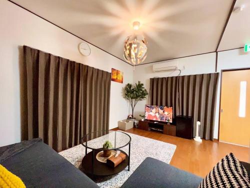 a living room with a couch and a tv at FUKU House in Tokyo