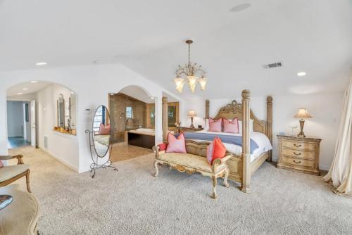 a large bedroom with a bed and a chair at Lakefront 3BR w Balconies Near French Qtr in New Orleans