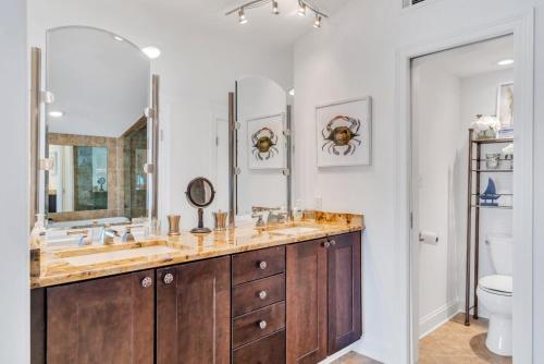 a bathroom with a double sink and a toilet at Lakefront 3BR w Balconies Near French Qtr in New Orleans