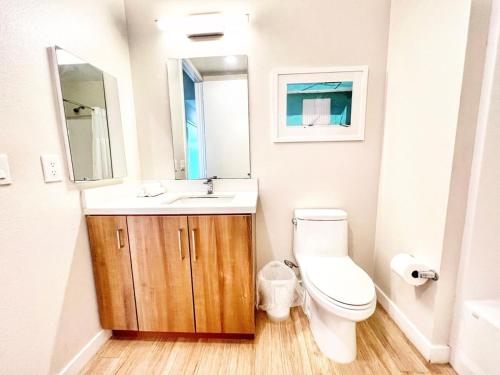 Un baño con inodoro, lavabo y espejo. en Beautiful One Bedroom Apartment With View Of City, en San Diego